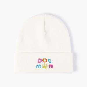 White knit beanie hat with colorful DOG MOM embroidery and green paw print design