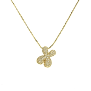 Detailed macro view of 18k gold-plated brass clover pendant with sparkling cubic zirconia