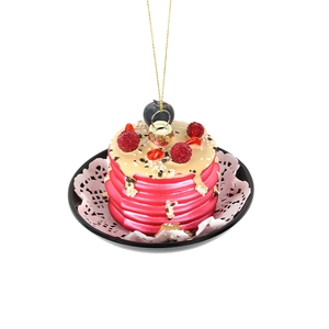 Handcrafted glass pancake ornament with colorful berries and golden hanging string