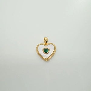 Macro detail of heart pendant with 18k gold plating, white shell, and green gemstone inlay