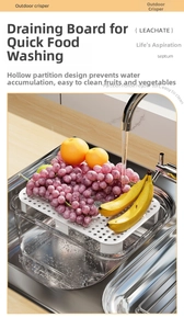 Detail of portable fruit box with white drain tray showing water washing fresh grapes