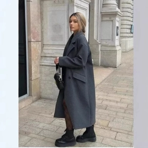 Women's long charcoal wool trench coat with notch lapel and oversized pockets in street style