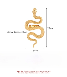 Detailed view of large gold snake earrings with measurements in centimeters and inches