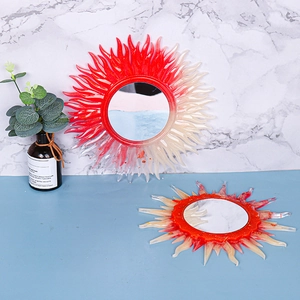 Detailed view of sun-shaped silicone mold crafts with red and white flame patterns