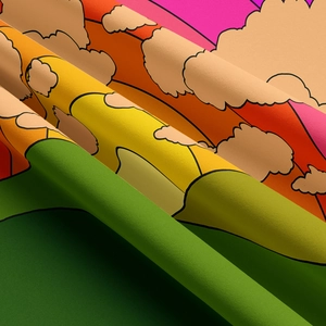 Close-up of bohemian rainbow tapestry fabric showing soft texture and cartoon landscape