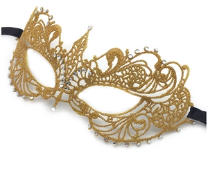 Macro view of gold lace masquerade mask showing intricate embroidery and rhinestone details