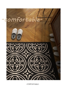 Macro view of woven fiber texture on black and cream geometric entryway door mat