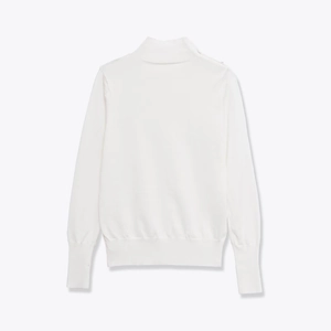 White turtleneck knit sweater featuring decorative shoulder buttons and ribbed cuffs