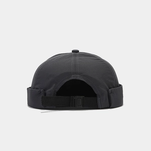 Detail view of adjustable plastic buckle and nylon strap on dark grey miki hat