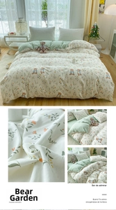 Detailed close-up of teddy bear embroidery and floral pattern on soft cotton duvet cover
