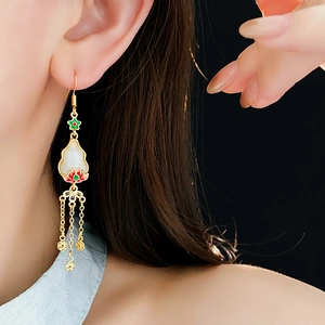 Detailed close-up of vintage lotus tassel earrings with colorful enamel and white glass stone