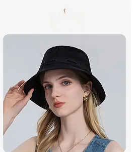 Detail of black breathable sun hat featuring mesh top and side drawstring adjustment