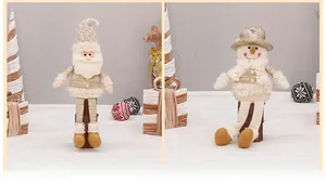 Detail of plush Santa and Snowman dolls with gold fabric and elegant pearl button accents