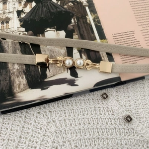 Elegant beige elastic waist belt with gold buckle and white pearls for dresses