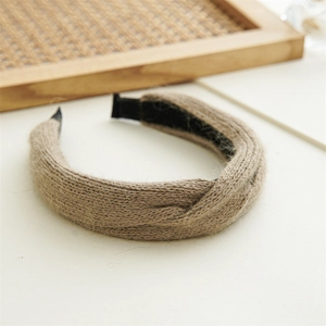 Macro shot of light brown knitted knot headband showing detailed weave texture