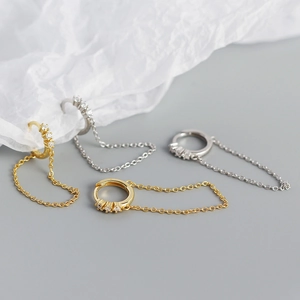 Detailed view of S925 silver chain tassel hoop earrings in gold and silver finishes