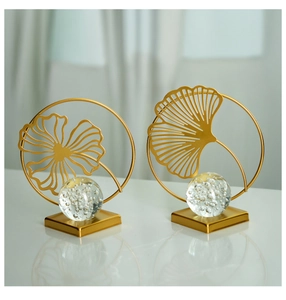 Close-up of golden metal leaf ornaments with crystal bubble spheres in minimalist style