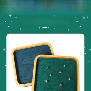 Detailed view of bamboo jewelry tray with dark green velvet slots for ring display