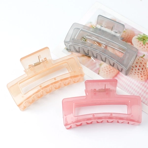 Three medium square jelly hair clips in grey orange and pink with transparent finish