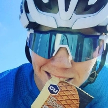 Outdoor cycling goggles with blue lens coating shown during a professional bike ride