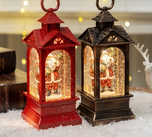 Close-up of lit Christmas water lanterns with Santa figurines and swirling glitter