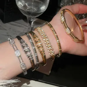 Elegant 18k gold plated cuff bracelet set with sparkling cubic zirconia on model's wrist