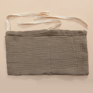 Detailed view of brown crinkled cotton storage bag with white herringbone tie straps