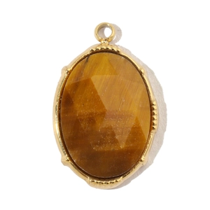 Macro view of oval tiger eye stone with gold-plated stainless steel faceted frame