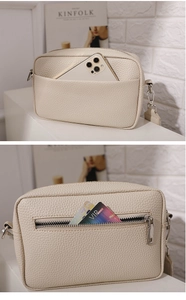 Detail view showing front pocket and rear zipper compartment of cream PU leather bag