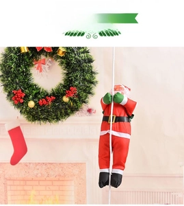 Detail of Santa Claus doll climbing a white rope with festive Christmas fireplace background