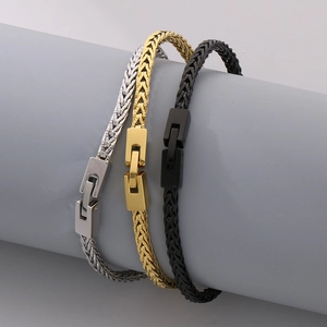 Detailed view of silver, gold, and black stainless steel dragon bone link bracelets