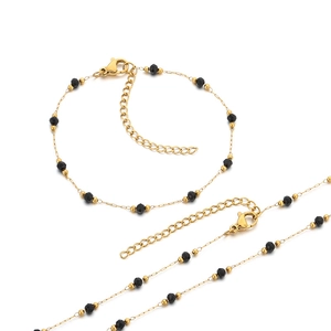 Golden titanium steel jewelry set with black beads and clover pendant charms