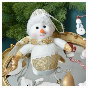 Classic plush snowman ornament with gold sequins on a decorative tray with pine branches