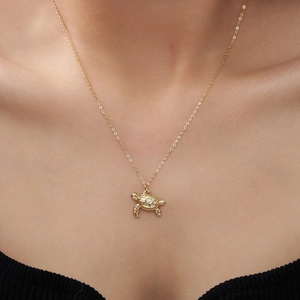 Golden sea turtle pendant necklace in S925 silver worn on neck to show length