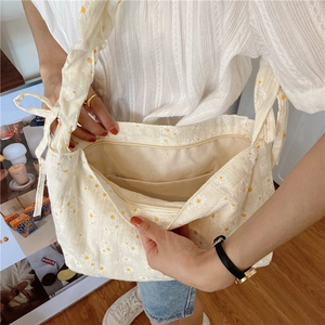 Detail view of the daisy canvas tote interior with zipper pocket and spacious lining