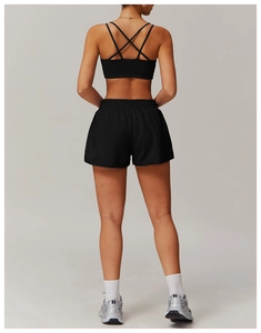 Detail of cross-back sports bra and breathable running shorts in a black yoga set