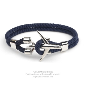 Detail of handcrafted dark blue Milan rope bracelet with silver airplane charm clasp