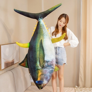 Detailed view of extra large realistic bluefin tuna plush pillow held by a person