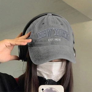 Detail of dark grey washed baseball cap with white NEW YORK EST.1625 embroidery