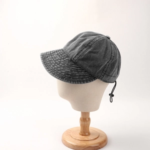 Dark gray washed denim sun hat with adjustable cord shown on a wooden mannequin head