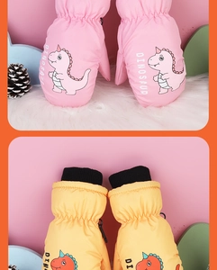 Detail of pink and yellow waterproof winter mittens for kids with dinosaur patterns