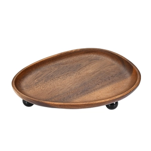 Dark walnut wood entryway key tray with ball feet stand on white background