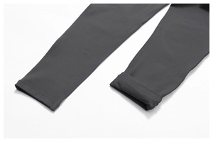 Detailed close-up of thermal fleece lining inside the hem of dark grey leggings