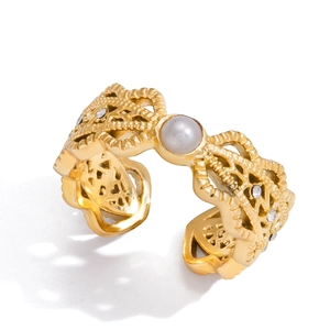 Gold plated hollow open ring with white pearl and sparkling zircon accents on white background