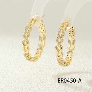 Detailed macro view of gold chain link hoop earrings with micro-paved cubic zirconia stones