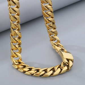 Detail of 20mm golden cuban link necklace showing polished texture and box clasp