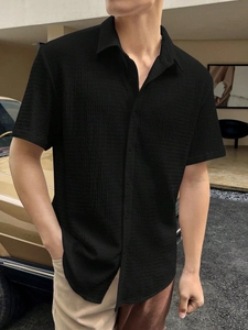 Detail of men's short sleeve shirt in black seersucker fabric with ripple texture