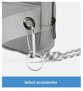 Detail of gray athletic waist bag showing strap, metal eyelet, and woven rope zipper pull