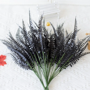 Detail of faux Boston ferns featuring unique black leaves with white edges in a bunch
