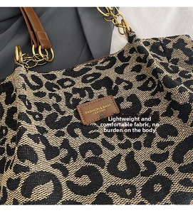 Close-up of leopard pattern tote bag with woven texture and gold chain leather strap
